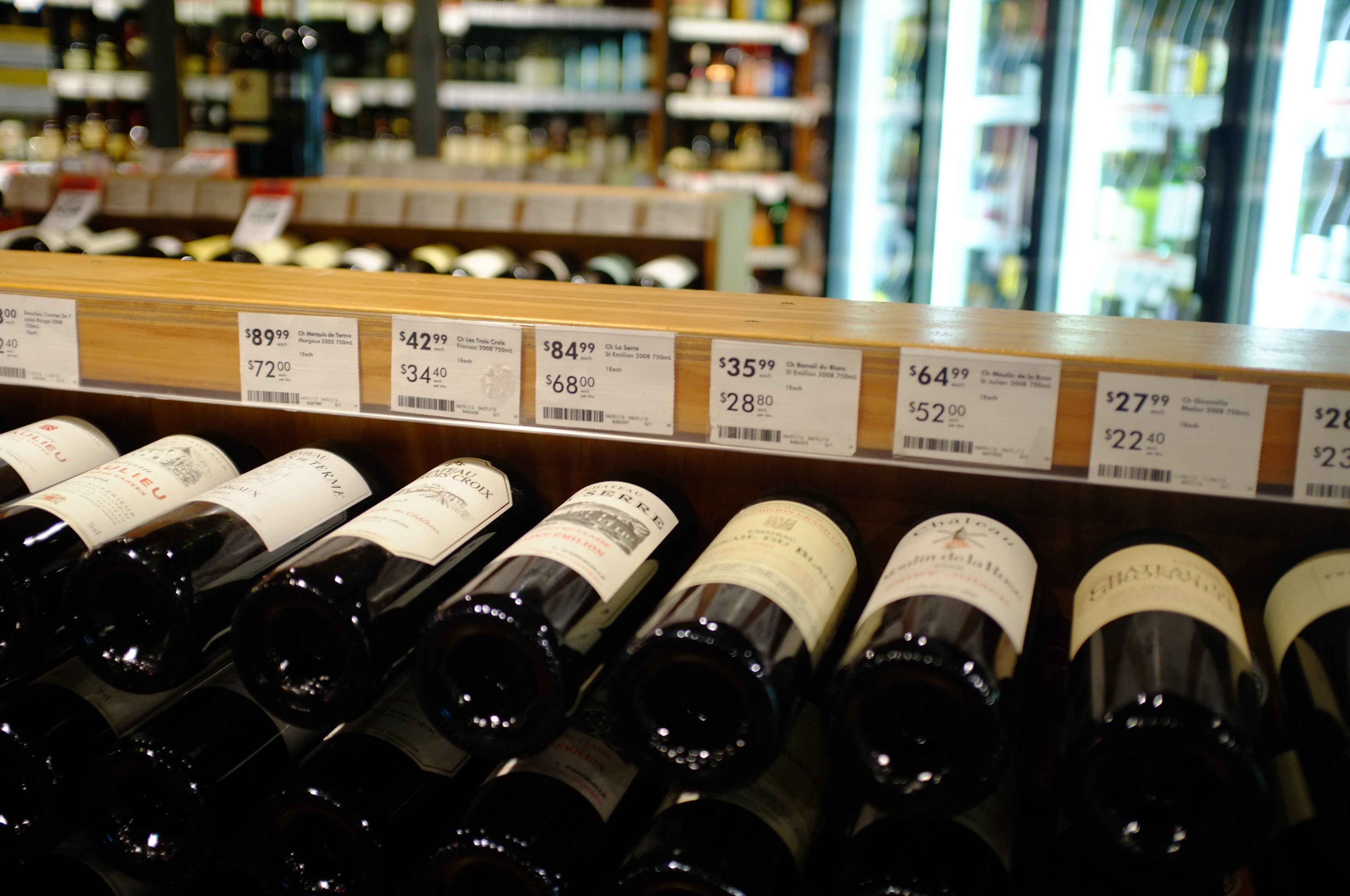 Wine bottles displayed with prices in a European shop