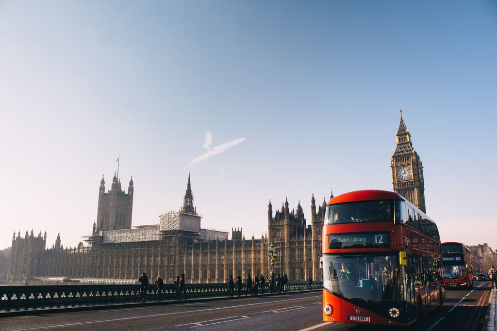Red double-decker bus passing Big Ben in London