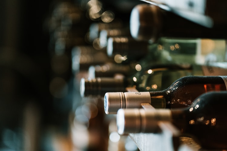 Wine bottles resting on a cellar rack
