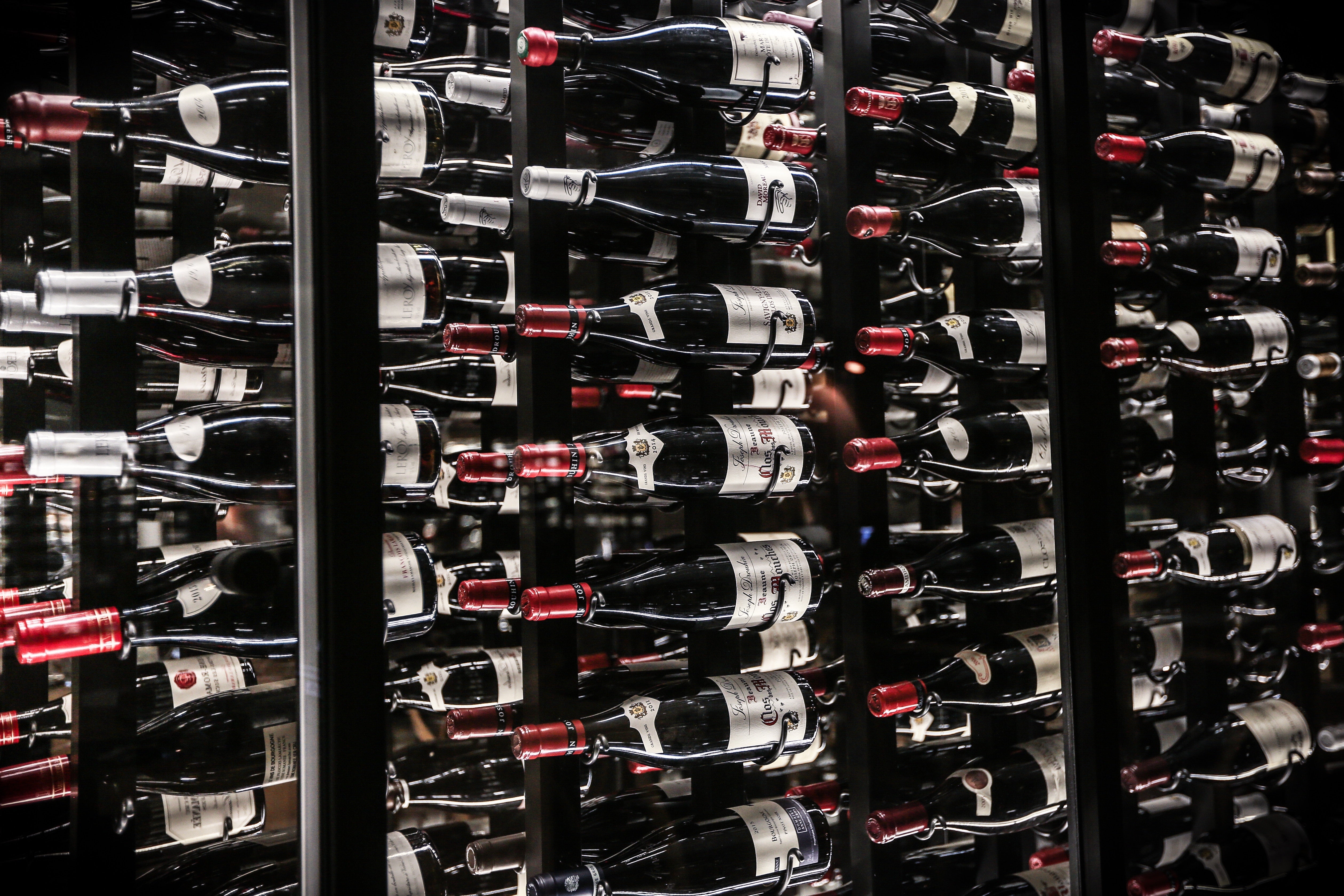 Wine bottles stored in floor-to-ceiling cellar racks